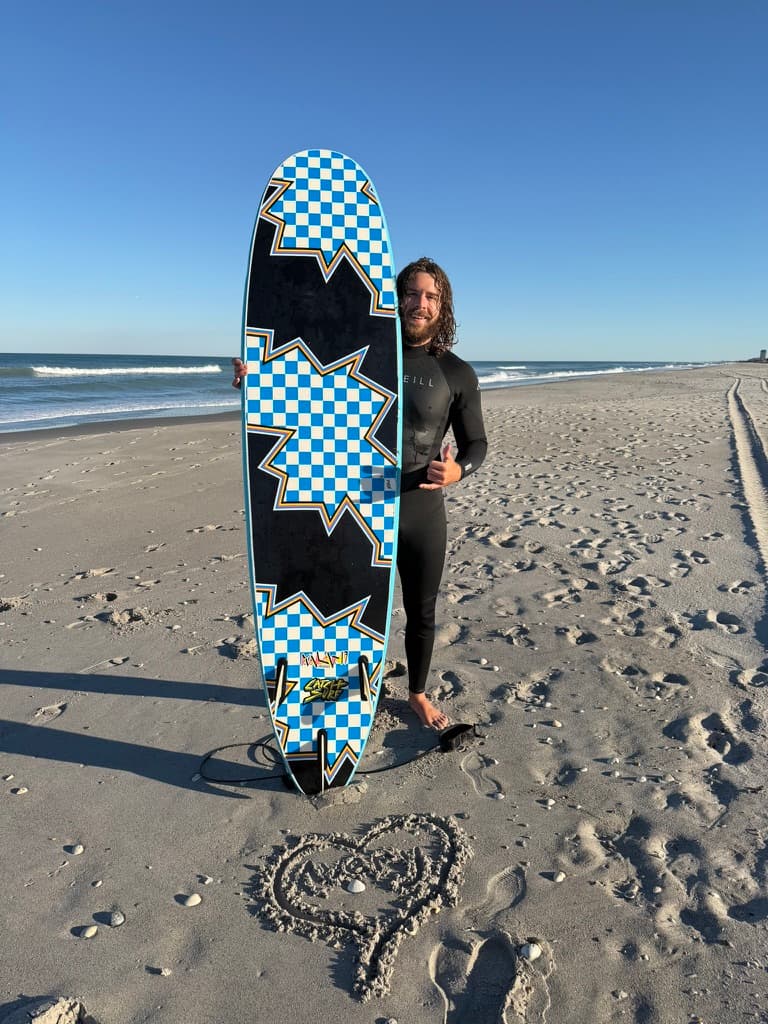 Coleman Crozier with surfboard on the beach