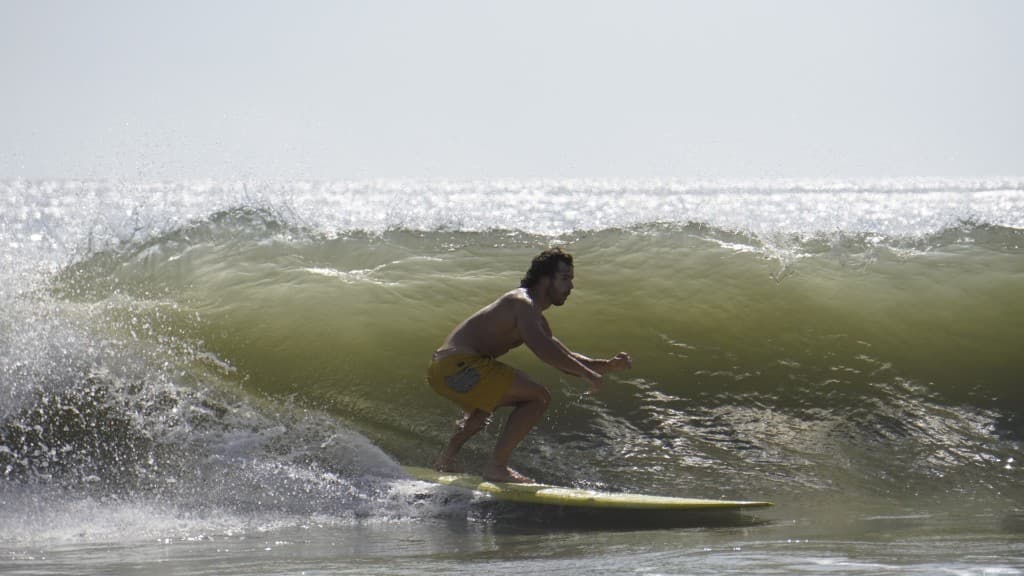 Grayson Crozier with surfboard on the beach